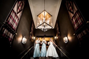 Bride and bridesmaids walking down the stairs at Dunblane Hydro