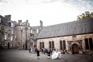 bridal party and guests walking at Stirling Castle courtyard