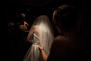 bride is dramatically illuminated by ceiling light
