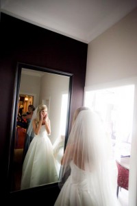 bride surprised at a full lenght mirror