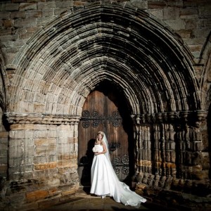 stunning bride in front of the door at Dunblane Cathedral