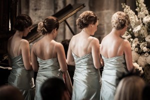 the backs of the bridesmaids in the cathedral