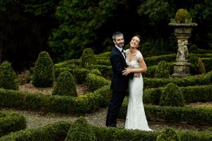 Bride and groom smiling in the garden