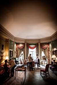 Bride bridesmaids and mother getting ready in beautiful large room