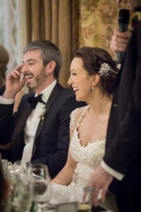 bride and groom laughing hysterically during the best mans speech