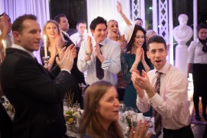bride and groom receive a thunderous applause from their wedding guests