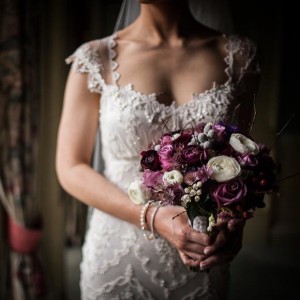 close of detail of brides boquet and dress