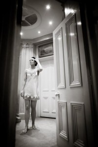 full length photo of bride adjusts her hair