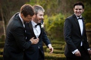 groom laughing with his groomsmen