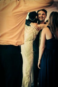 the bride hugs a wedding guest on the dance floor