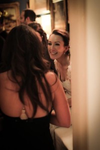 the bride smiling at one of her guests during her wedding reception