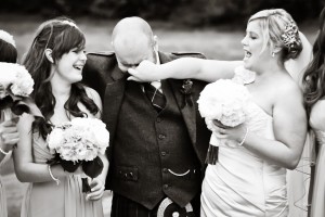 bride grabs groom's nose during wedding photos