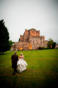 bride and groom walk in grounds of dalhousie castle