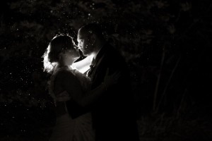 bride and groom kiss in dark