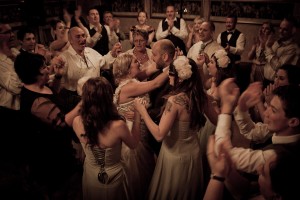 bride and groom dance surrounded by family and friends