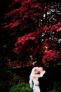 bride and groom with autumn leaves