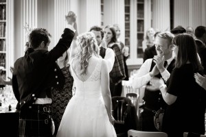 bride and groom cheer at wedding in signet library edinburgh