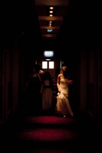 bride and bridesmaids in dark corridor