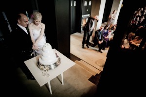 bride and groom cut cake at house for an art lover in glasgow