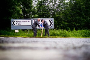 groom putting out signs for wedding guests