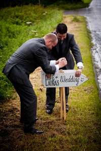 groomsmen put out signs for wedding guests