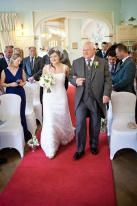 bride coming down aisle with father at solsgirth house wedding