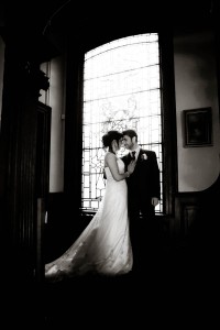 bride and groom by tall window at Solsgirth House