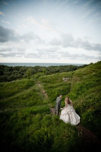 bride and groom on grassy hillside at outdoor wedding