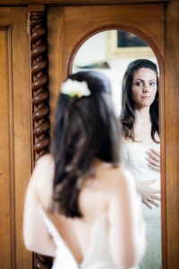 bride in mirror getting ready