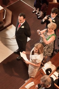 groom waits as bride comes down aisle