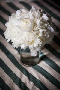 white wedding flowers on striped tablecloth