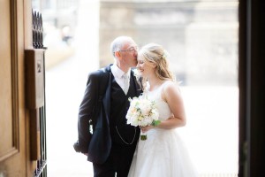 father kisses bride at wedding at signet library edinburgh