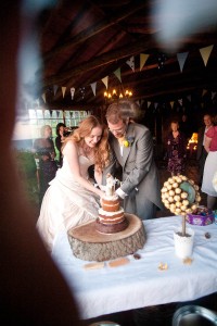 bride and groom vut quirky cake at wedding reception at ravensheugh log cabin