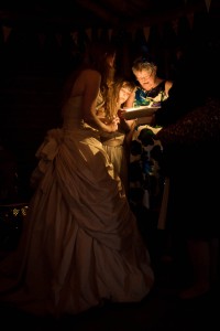 bride in dark with wedding guests