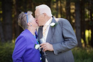 bride's parents kiss at outdoor wedding