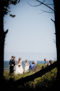 wedding ceremony on beach through trees