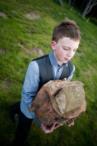 boy with logs for firewood at wedding