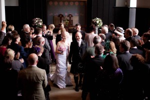 bride and groom walk up aisle after wedding ceremony