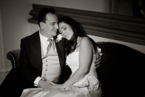 newly wed couple snuggle at wedding at drummuir castle black and white
