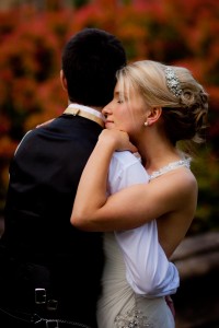 bride and groom embrace outside
