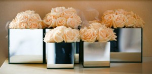 whirte roses in shiny square vases