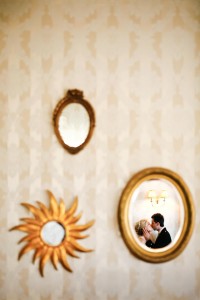 bride and groom kiss reflection in mirror