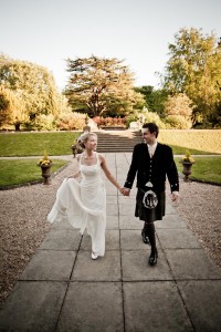 bride and groom walk in grounds of mar hall glasgow