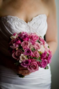 bride holding bouquet of pink roses
