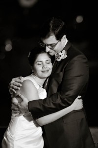 bride and groom embrace in black and white.