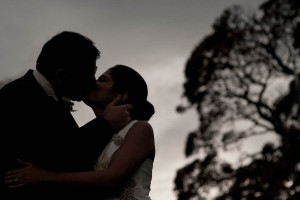 bride and groom kiss outside
