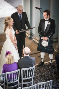 bride and groom smile at front at wedding in signet library edinburgh