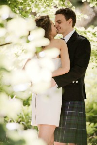 bride and groom embrace with tree