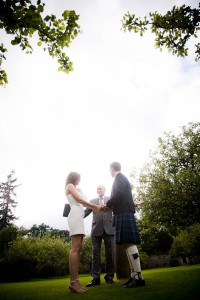 bride and groom make vows in garden