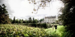bride and groom walk in grounds of traquair house